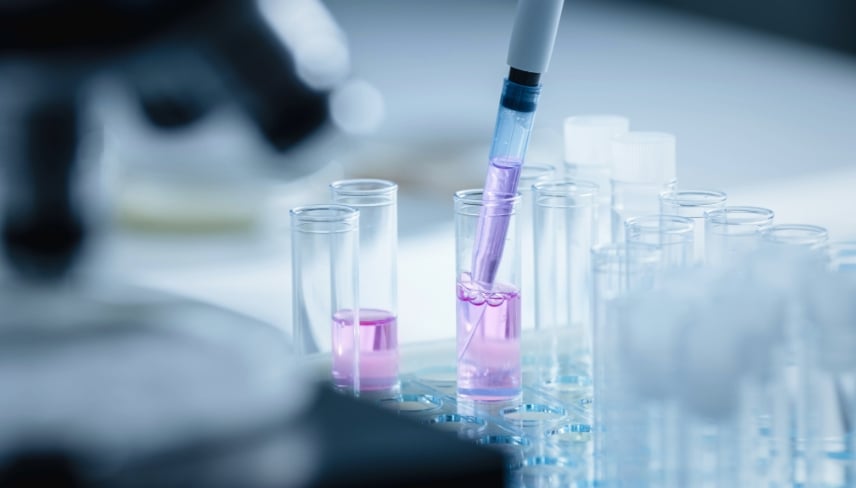 Close Up Shot of a Scientist Using Micro Pipette and Mixing Chemical Liquid with Genetically Modified Samples Under a Microscope. 